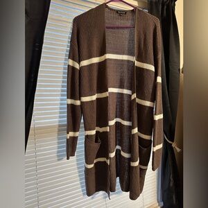 Sweater cardigan with pockets. Color is a purplish brown with white stripes.